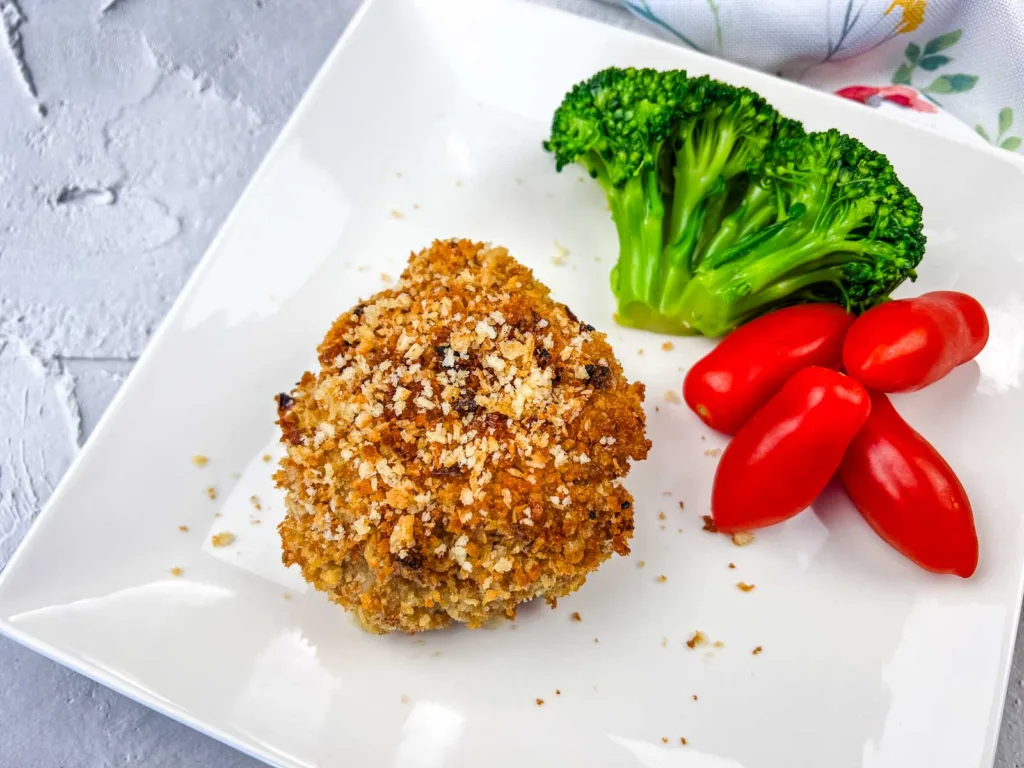Copycat HelloFresh Crispy Shallot Croquettes on a white plate with tomatoes and broccoli.