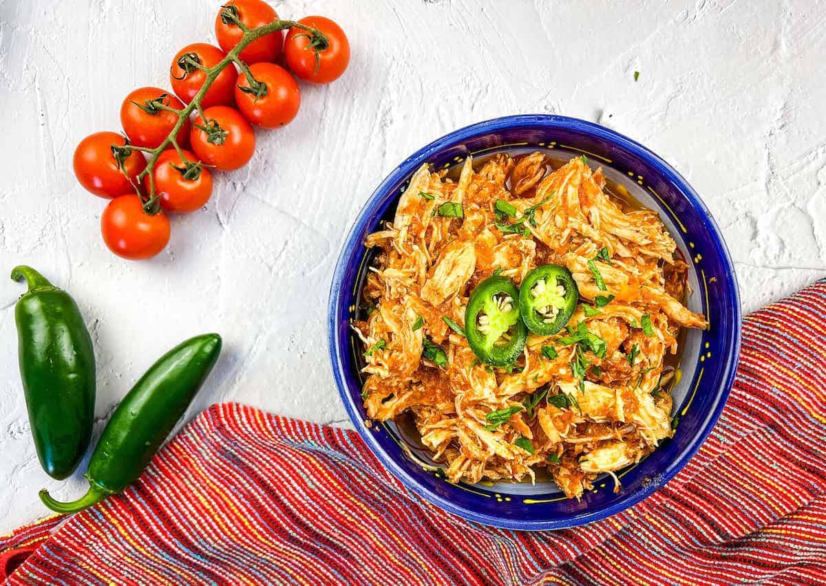 Chicken tinga in a blue bowl.