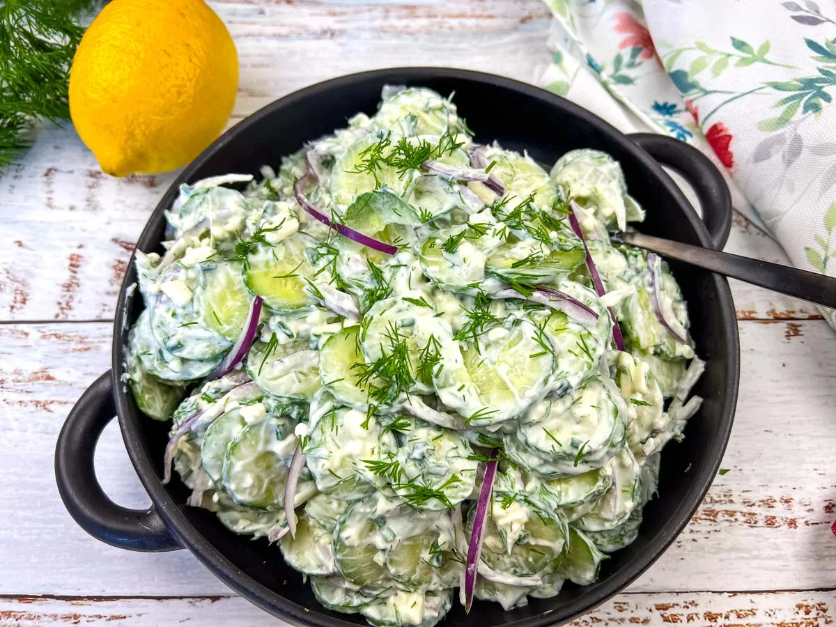 Cucumber and Feta salad in a black bowl.