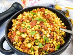 Bacon Fried Corn on a black skillet.
