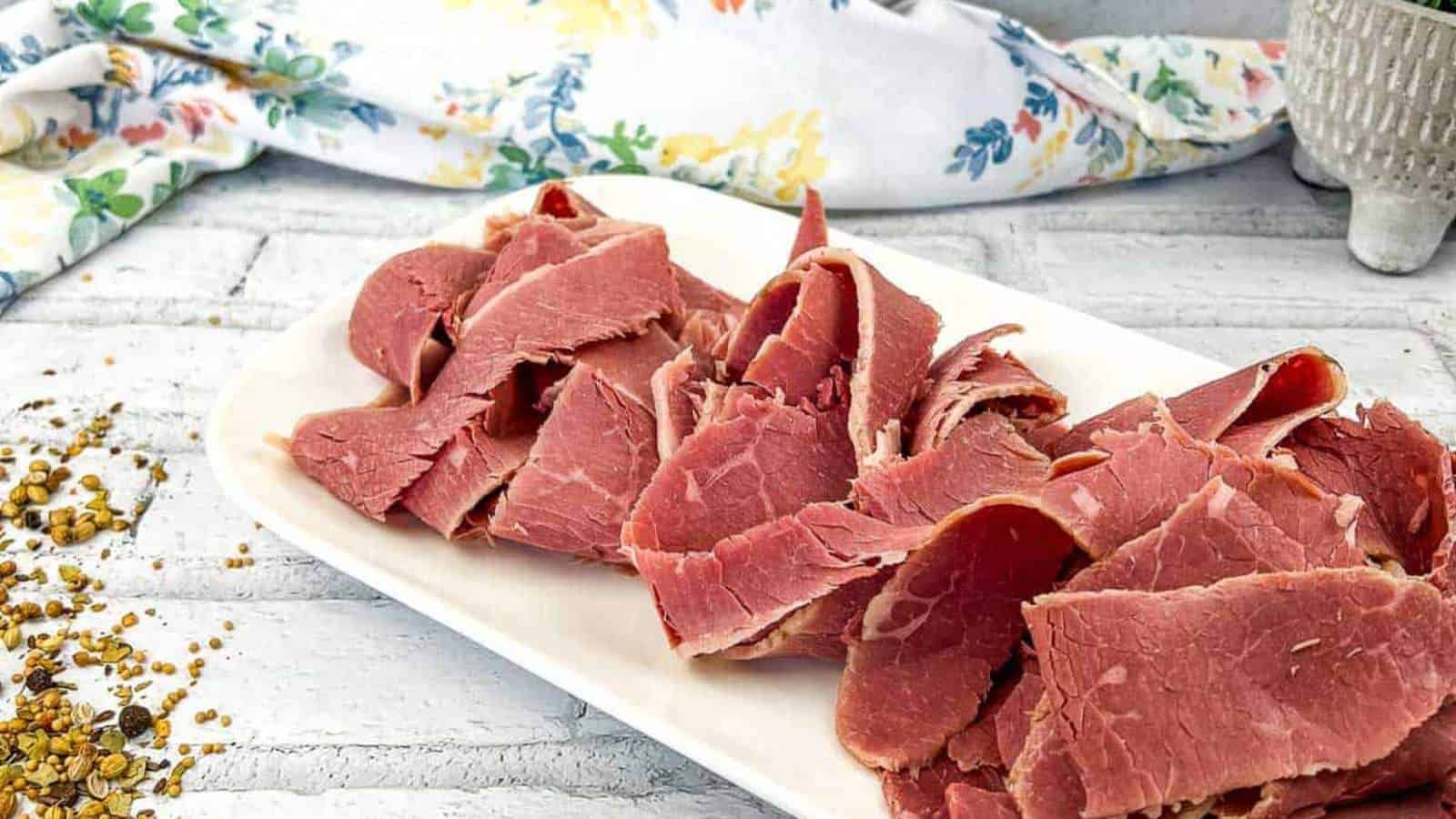 Homemade corned beef on a white plate.