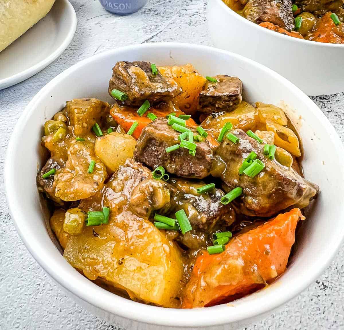 A white bowl filled with smoked beef stew.