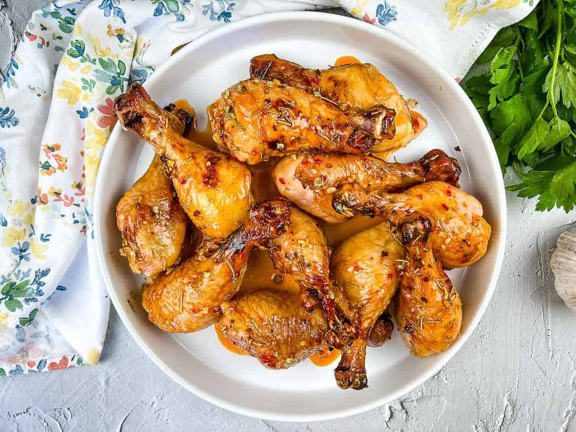 A plate of Smoked Chicken Legs with Red Pepper Glaze.