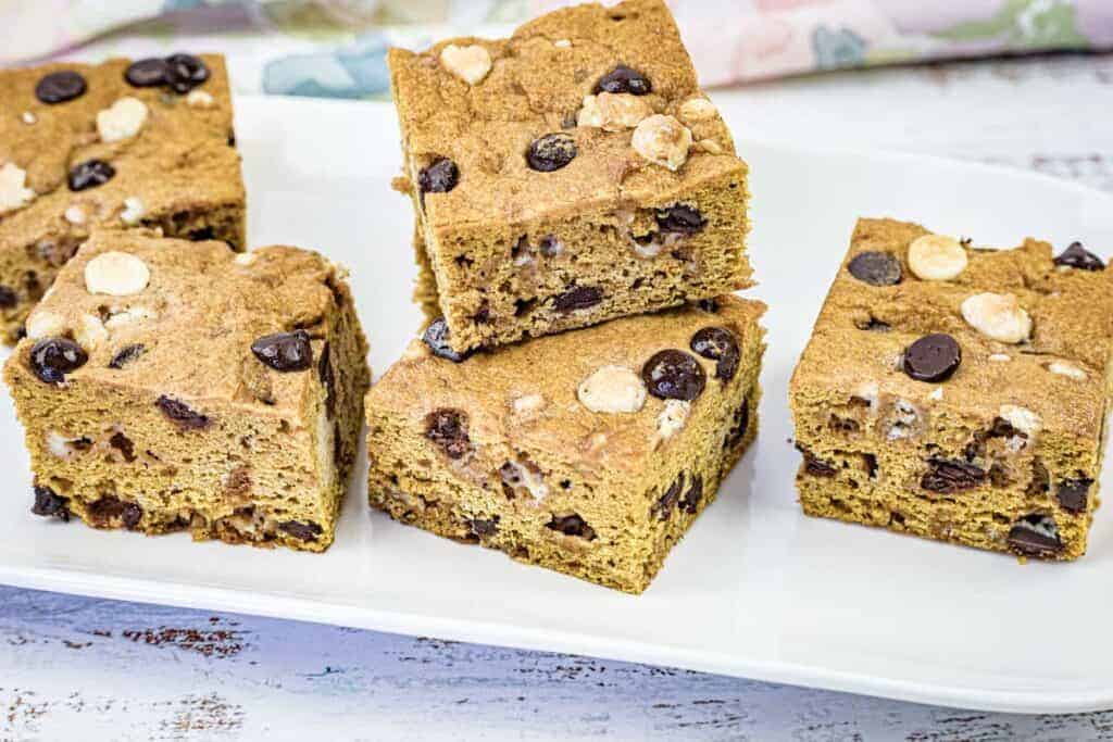 Close-up pumpkin blondies on a white plate.