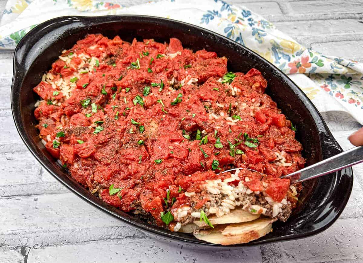 Shipwreck Casserole in a black dish with a spoon.