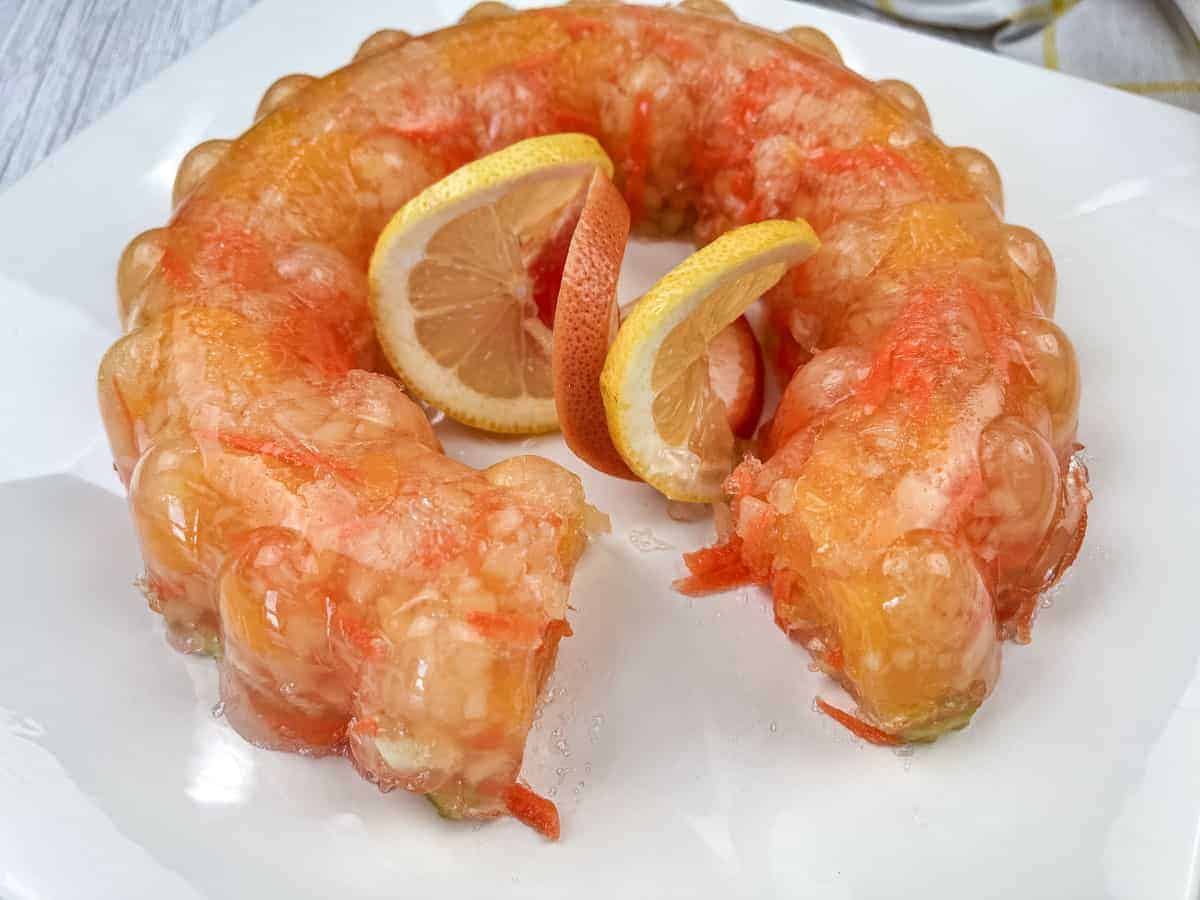 Sunshine salad with slices of oranges in the center served on a white plate.