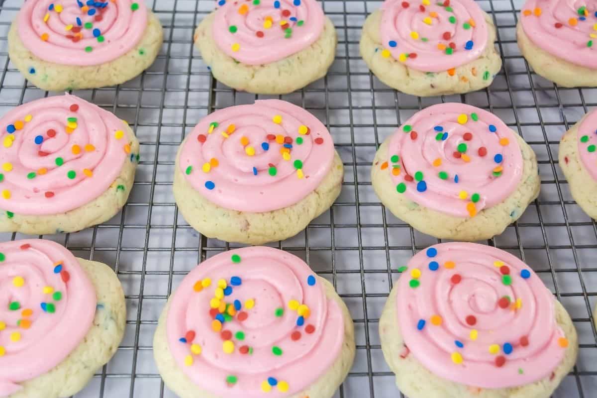 Crumbl Confetti Cake Cookies are arranged on a cooling rack.